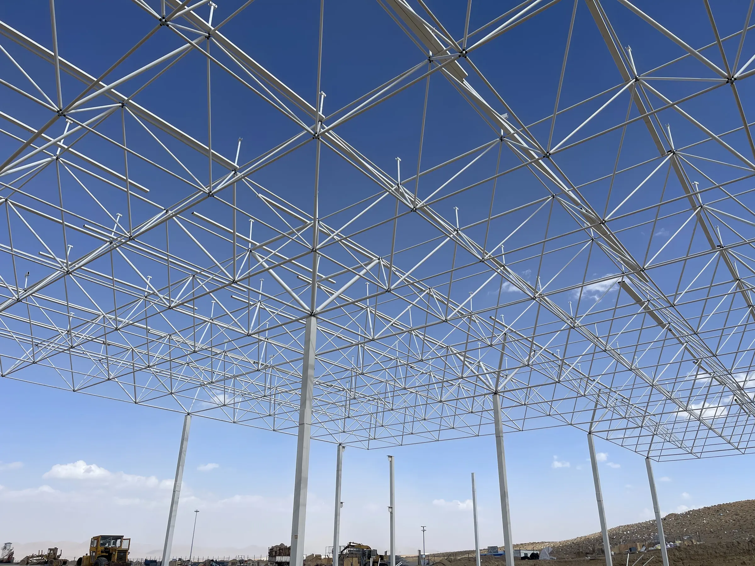 The Arian Motor space frame from below, the full bay complete against clear sky