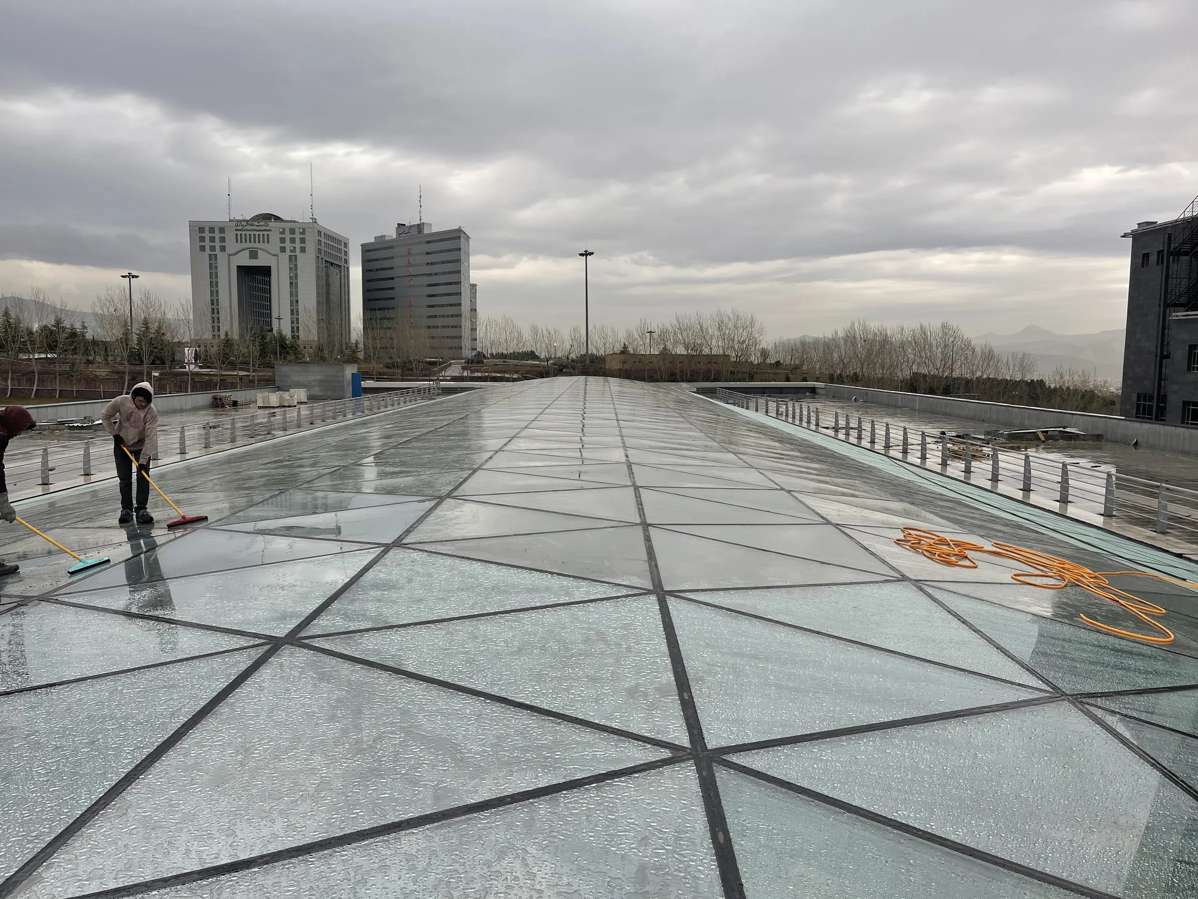 The Auto Mall skylight being cleaned down after glazing, the city under cloud