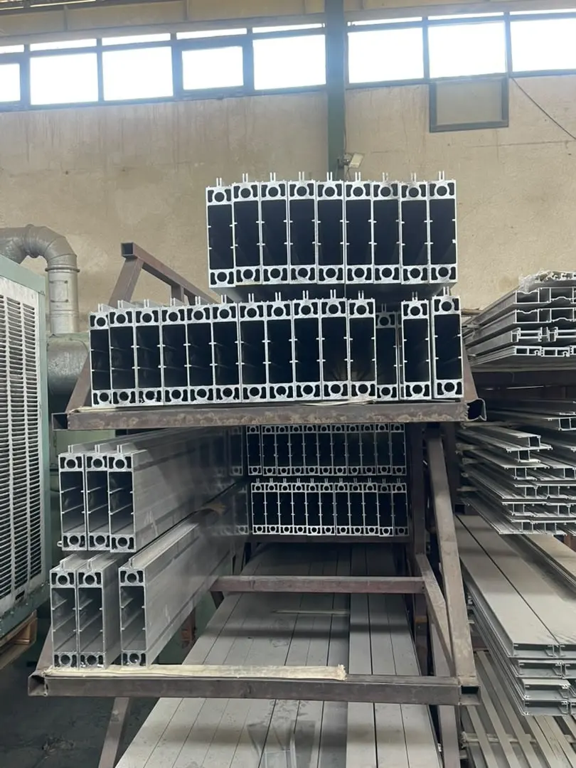 Aluminium profile sections for DOMAINE, stacked in the workshop