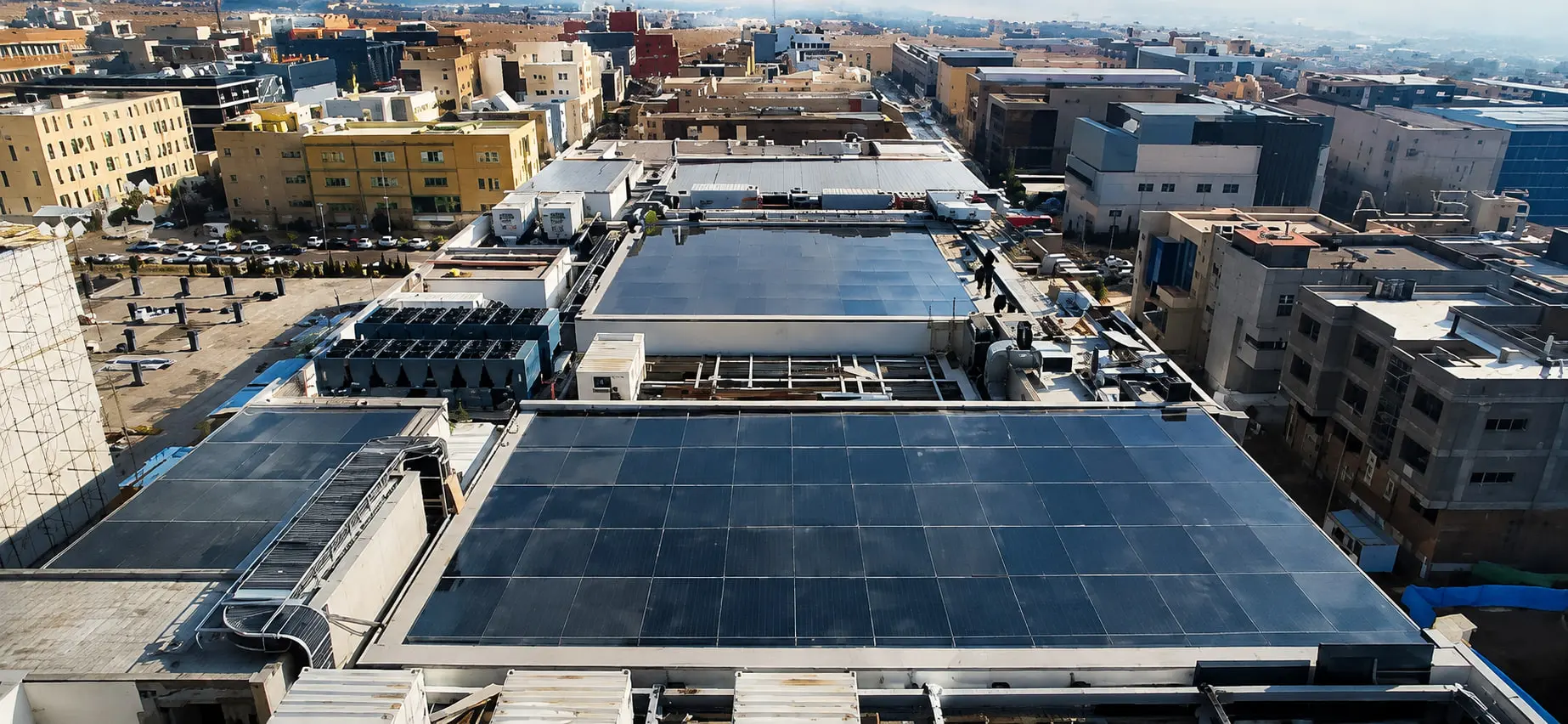 The Fanap glass roofs at closer range, the glazed bays running to the parapet with plant alongside