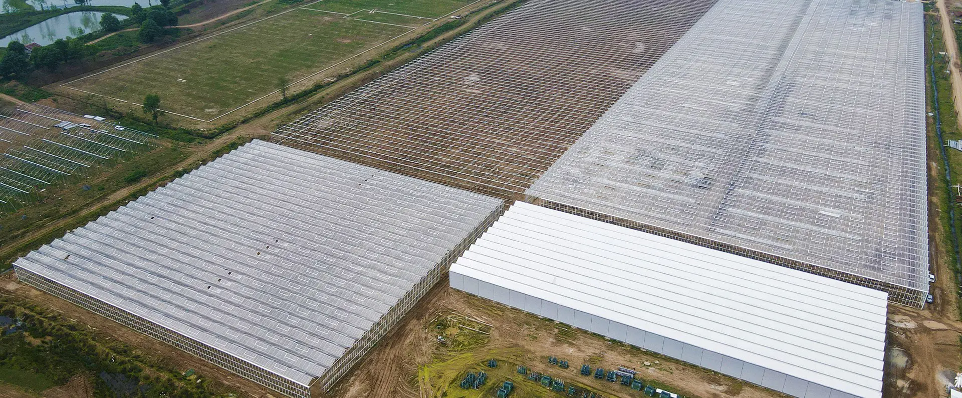 Two greenhouse blocks and the packing hall seen from the air