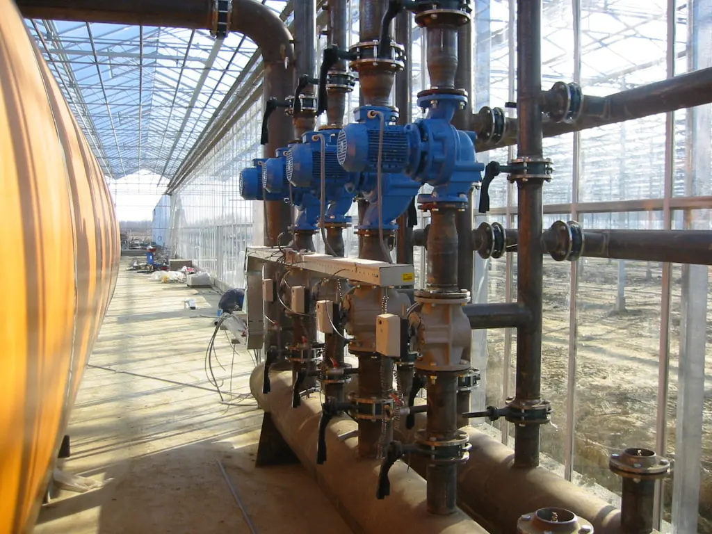 Heating distribution manifold with valves and circulation pumps beside the buffer tank