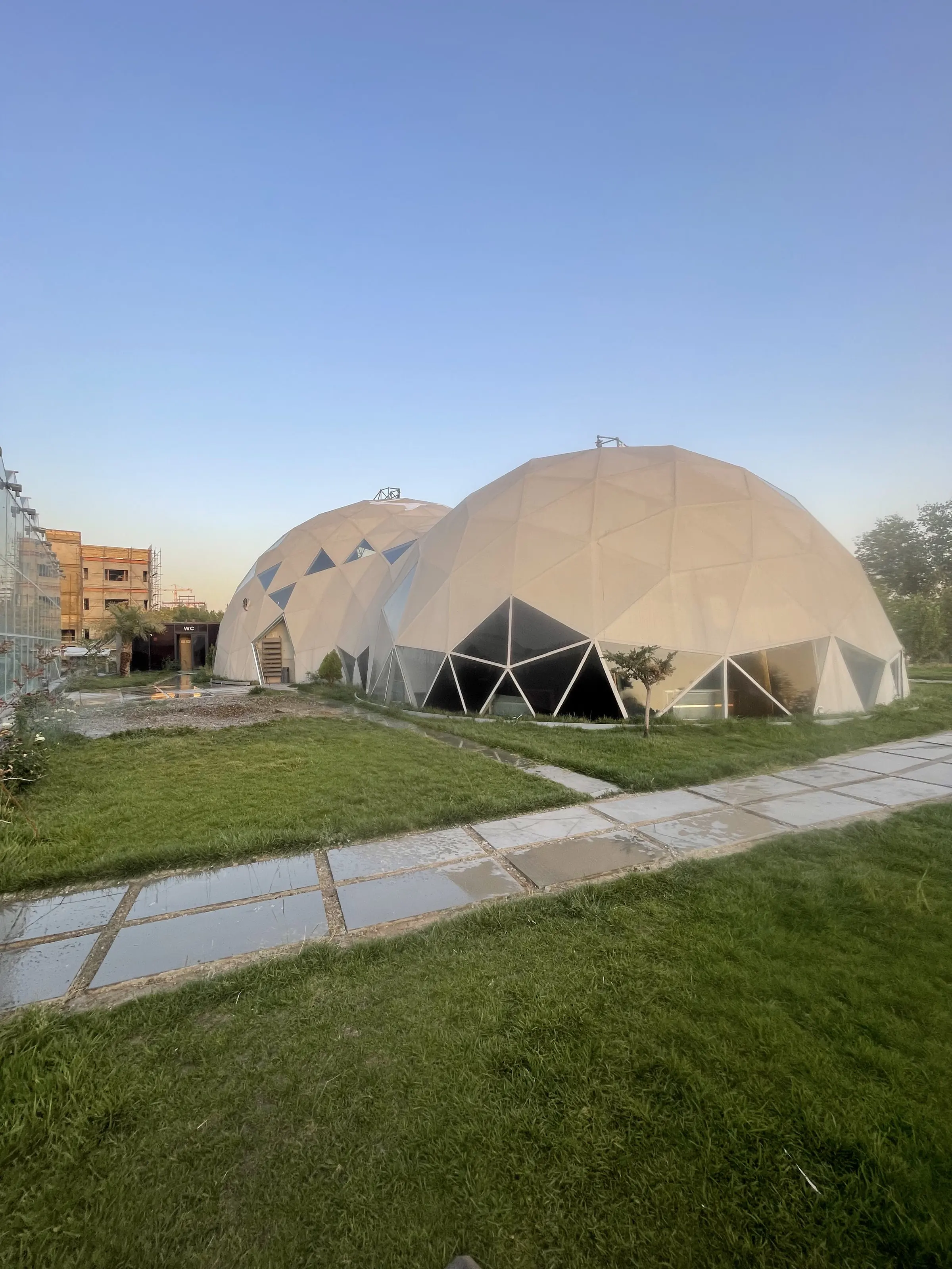 The completed and clad domes of the Middle East Plant Research Center seen across the lawn