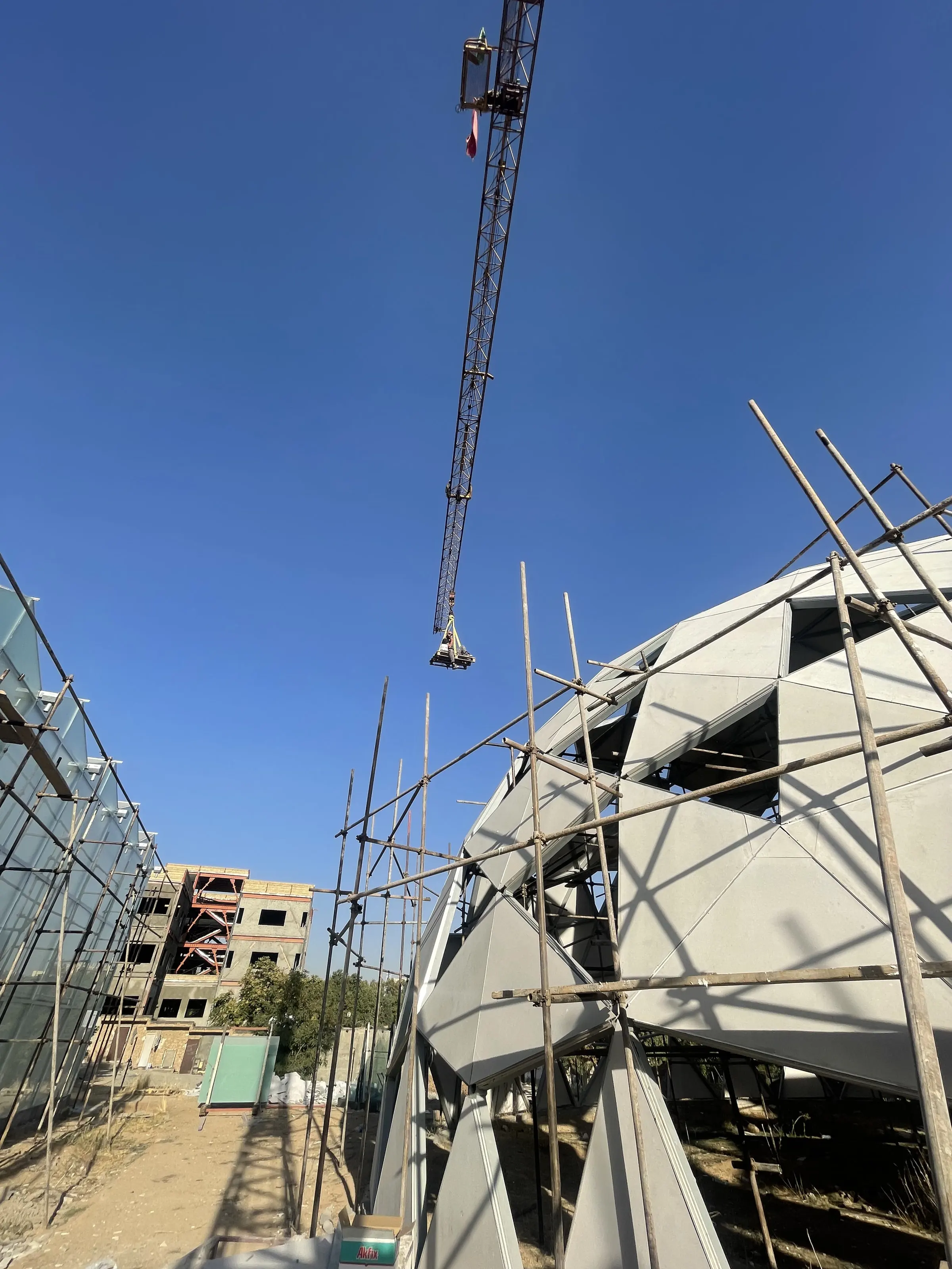 Scaffold and crane against the research centre dome during cladding