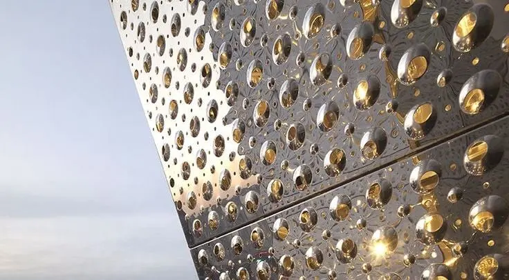 Reference image: a metal panel with perforations graded in size across its face