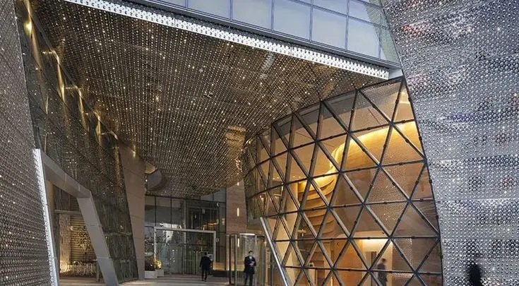 Reference example 2 of perforated metal dry façade — punched metal screens and second skins